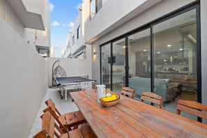 Relax outside with a game of ping pong, a comfy swing chair, and a spot for outdoor dining.