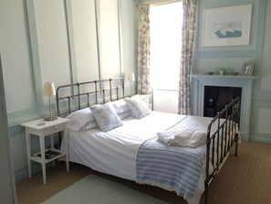 King Sized Bed and Wood panelling in the bedroom - towels provided.