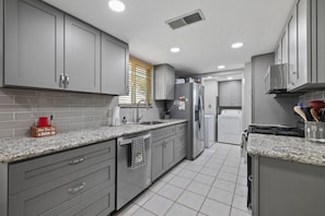 Open galley kitchen fully stocked with everything you need to make a meal