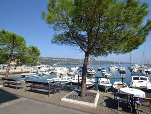 Sky, Water, Tree, Shade, Vehicle, Boat, Watercraft, Woody Plant, Outdoor Furniture, Lake