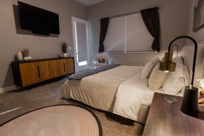 Primary bedroom has door to patio, smart TV, attached bath and walk-in closet.