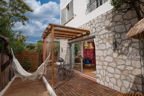 Private terrace with hammock and outdoor dining area. Perfect for relaxation at Mandara Beach, Juan-les-Pins.