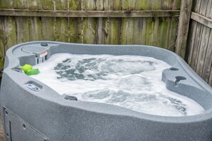Step outside to your private fenced backyard oasis featuring a relaxing hot tub for the perfect end to any day!