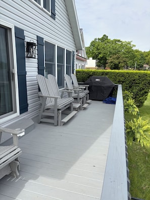 Deck with ample seating and Weber grill overlooking the lake.