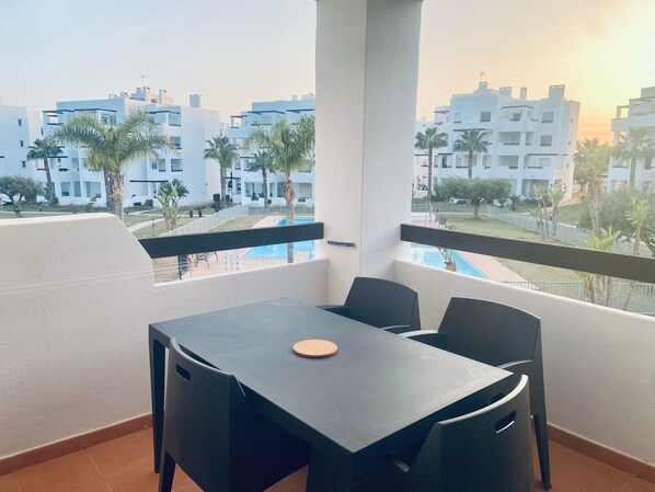 Balcony with golf course and pool view