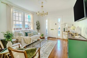 The living space features a Smart TV and pull out couch.