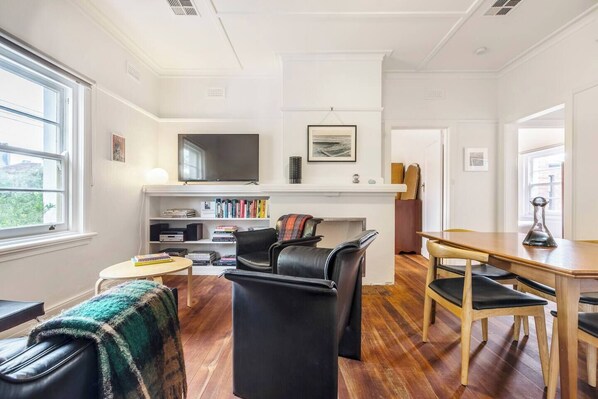 The living room adjoins the dining area, creating an effortless social flow. Enjoy relaxing together in the comfort of air-conditioning and central heating for cooler months.