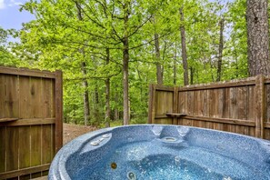A secluded hot tub experience awaits you, offering a serene retreat where you can enjoy the sights and sounds of nature.
