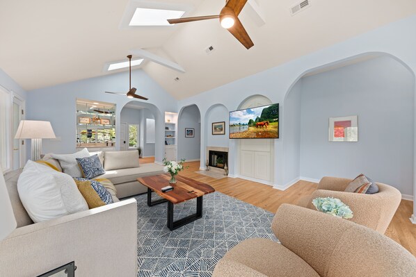 Vaulted ceilings and skylights fill the great room with natural light