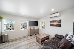 Living room w/65-inch Smart TV & WIFI and scenic windows & photo canvas wall art