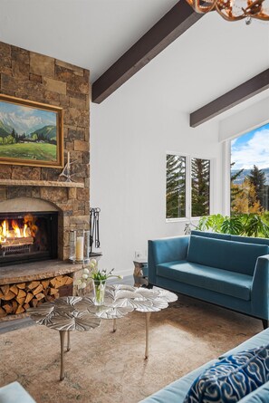 Cozy up by the wood-burning fireplace from any of the living areas.