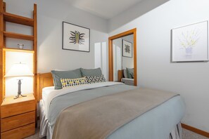 An inbuilt closet is by the main bed for convenient storage. 