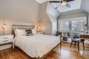 Comfortable queen size bed situated with creative architecture and charm