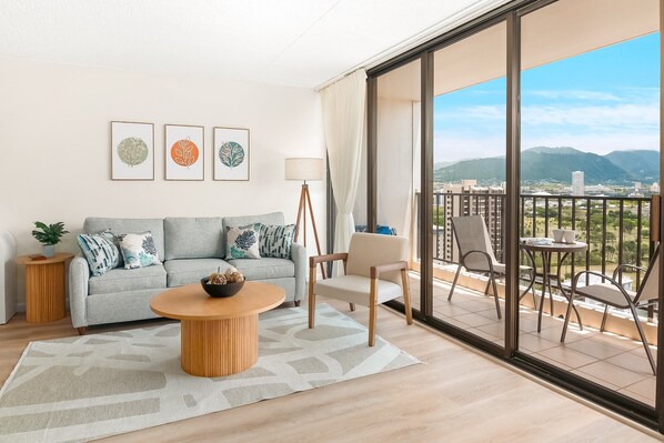 Living area with pull-out sleeper sofa, a coffee table, and an armchair.