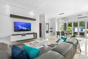 Experience ultimate comfort in the inviting living and dining area, where open space beckons you to unwind while soaking in the picturesque view of the pool area.