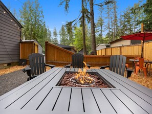 Cozy up by the modern fire table! Perfect for sharing stories and s'mores on cool evenings.