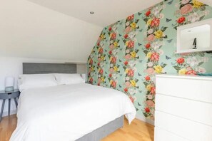 The main bedroom (double bed) has a large chest of drawers, hanging space and bedside tables. 