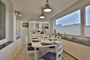 Nautic Lounge 45 – Stilvolles Esszimmer mit weißen Möbeln und großen Fenstern, maritimes Ambiente in Scharbeutz-Haffkrug