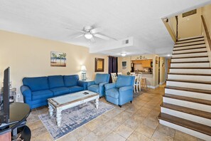 Living room with a sleeper sofa, 2 chairs and a smart TV