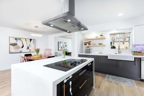 A modern , fully stocked and spacious kitchen ready for you to make a delicious meal 