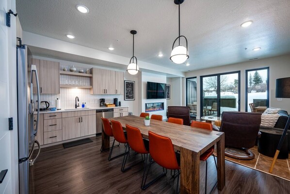 The open-concept living space, complete with a dining area, facilitates effortless conversation with family and friends.