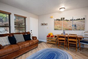 The open-concept living space, complete with a dining area, facilitates effortless conversation with family and friends.