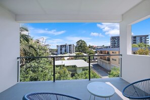 A seating nook on the balcony offers a peaceful spot to unwind with a book and enjoy some fresh air.
