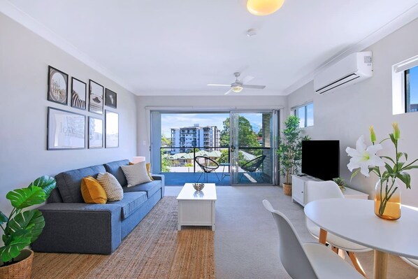 The open-plan living room flows to the balcony, creating a lovely transition between the indoors and out.
