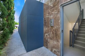 A modern entrance greets you on arrival. The apartment is located on the second level.
