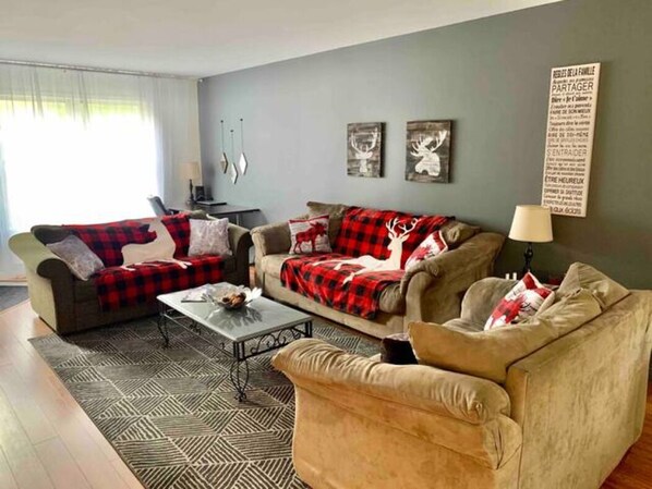 Living room with smart TV and desk with screen for teleworkers