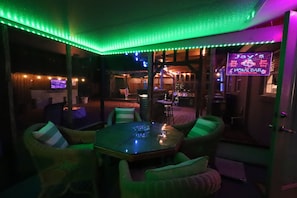 Enclosed lanai at night in Tiki Courtyard