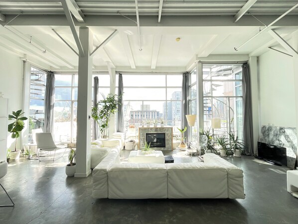 Open concept penthouse loft with large deck and rooftop. 1400 sf.