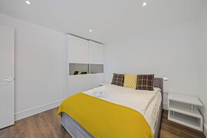 Massive bedroom with king-sized bed and built-in wardrobe