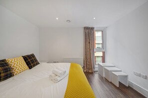 Massive bedroom with king-sized bed and built-in wardrobe