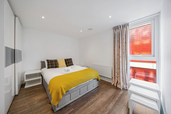 Massive bedroom with king-sized bed and built-in wardrobe