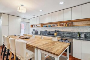 This open kitchen allows you the ability to cook meals or just sit around the spacious dining table that accommodates up to 8 people. 