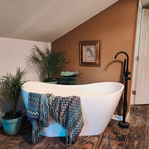 Ensuite, romantic soaking tub in the open bedroom.