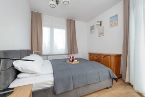 Bedroom with a comfortable double bed and chest of drawers.
