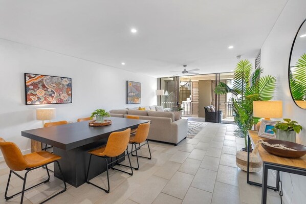 Dine together on the stylish wooden six-seater table with tan leather chairs. 
