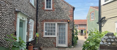 Triple aspect flint cottage formerly a “cart shed /gig house”
