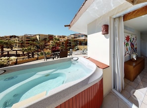 Private jacuzzi luxury with a stunning resort view.