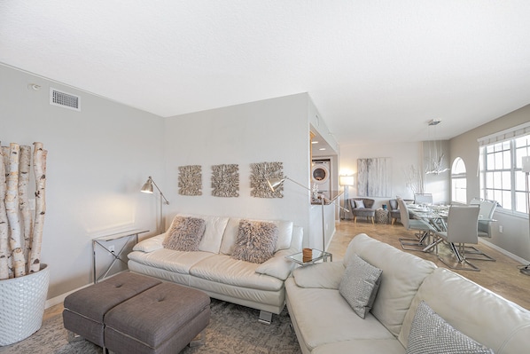 Enjoy the spacious open-plan living room area, complete with a smart TV and breathtaking views of the bay.