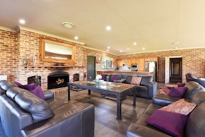 The open fire place with huge open plan living room with glass and cast iron table