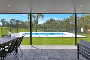 Lodge back yard pool and entertaining area. The private 8 meter swimming pool out door dining area and lounge area.