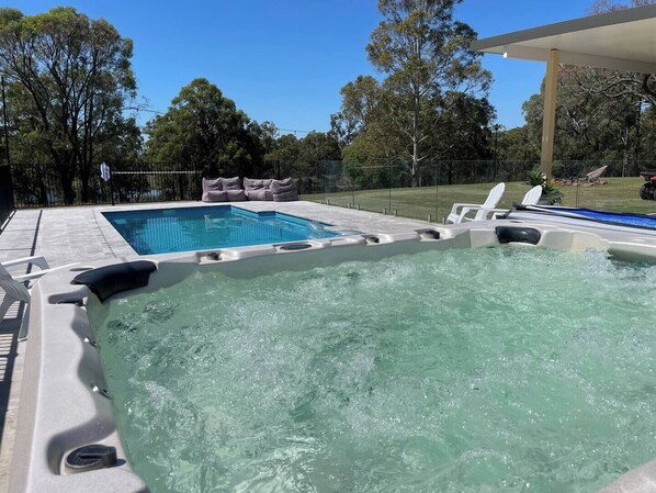 Huge hot spa and pool area situated next to the outdoor entertaining area and firepit. 