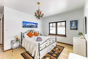 Rest in the main bedroom w/ ensuite bath, feat. wrought iron pieces from Italy.