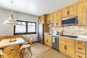 Savor culinary delight in the custom kitchen. SS appliances, gas stove, no oven.