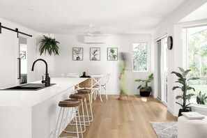 Modern and stylish open plan living flowing from kitchen to dining to outdoors