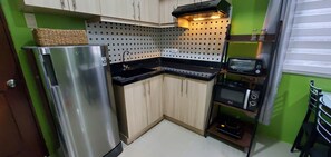 Fully equipped kitchen with small appliances in the cabinet