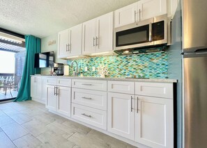 Kitchen w/full fridge is set to whip up a little something whenever you want.